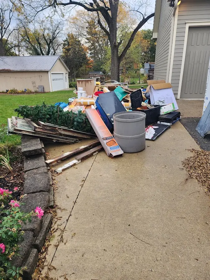 Dumpster being loaded with debris for Roofing Dumpster Rental in Carolina Beach